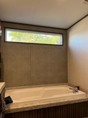 living with pulmonary fibrosis | Pulmonary Fibrosis News | A long, rectangular window over a bathtub in Ann's home looks out at a tree and the sky.